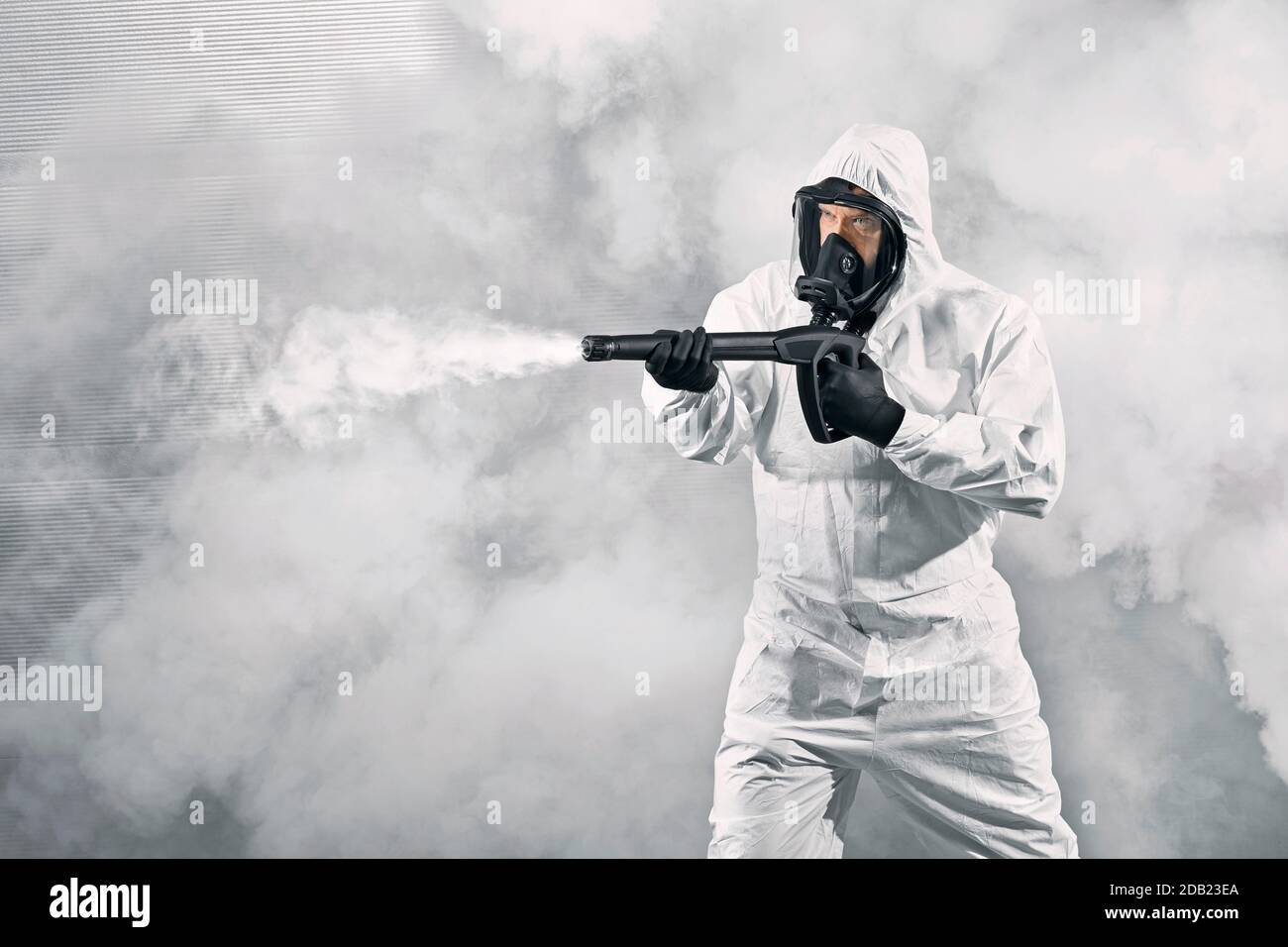 GERMANY / Frankfurt Main /Disinfecting personnel wearing protective suits and mask as a preventive measure against viruses. Stock Photo