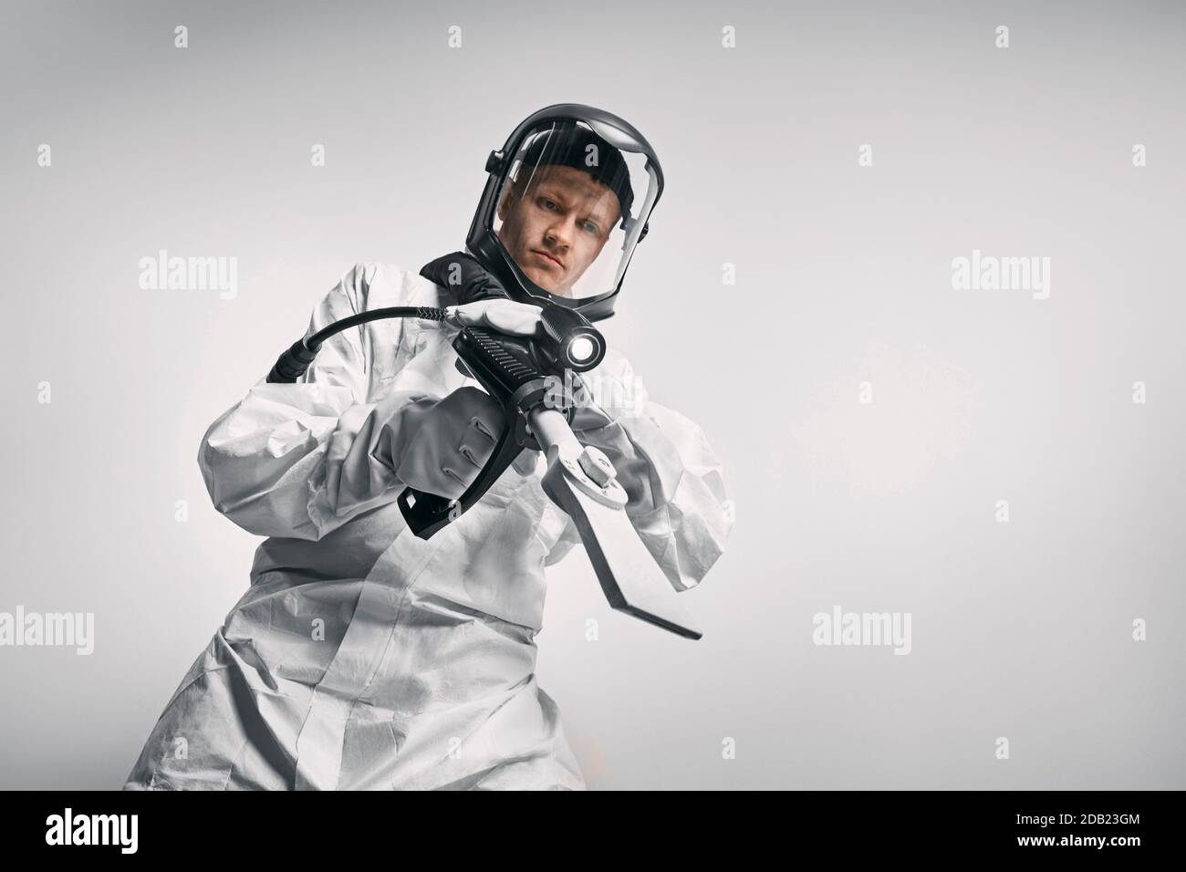 GERMANY / Frankfurt Main /Disinfecting personnel wearing protective suits and mask . Stock Photo
