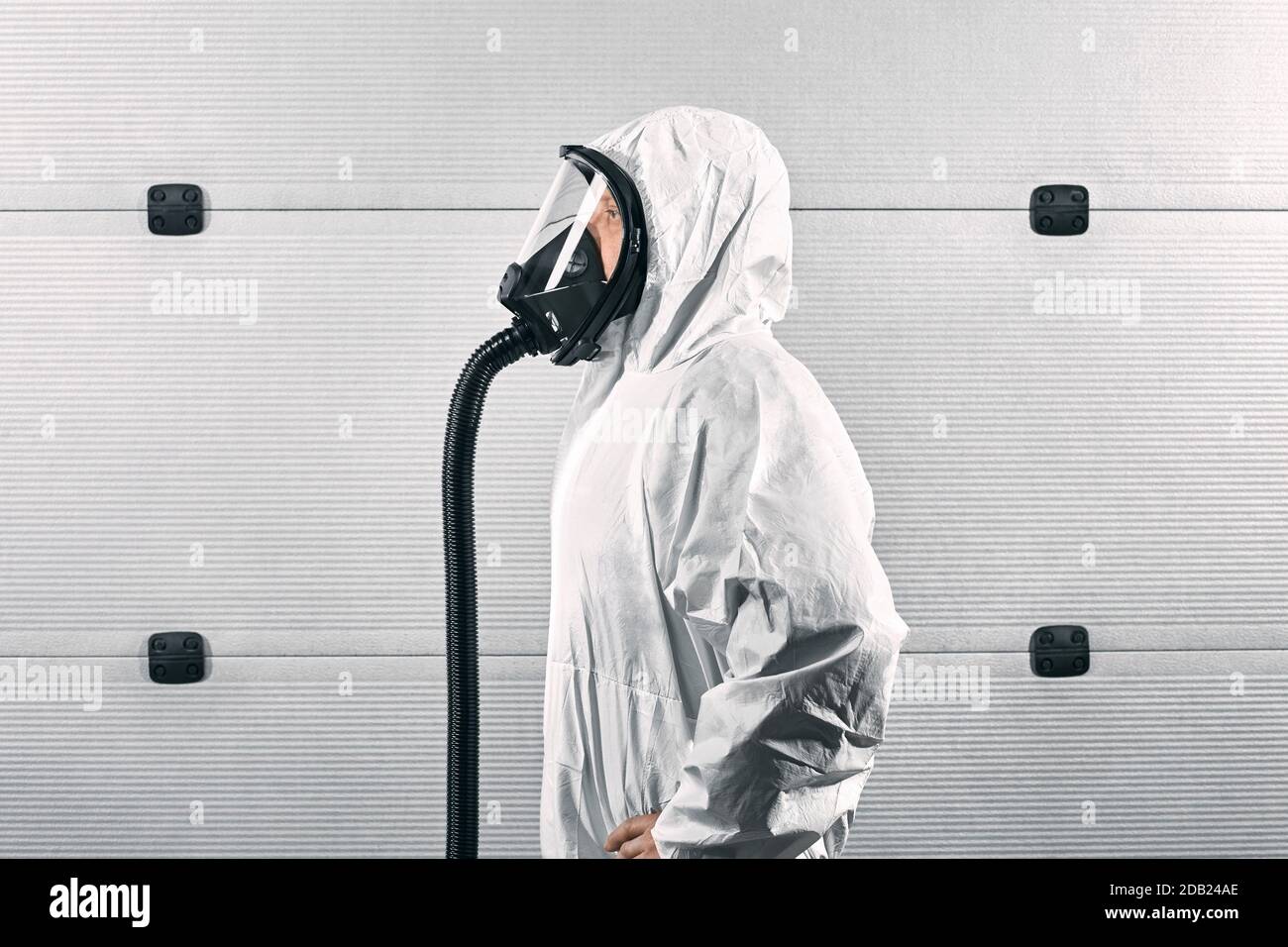 GERMANY / Frankfurt Main /Disinfecting personnel wearing protective suits and mask as a preventive measure against viruses. Stock Photo