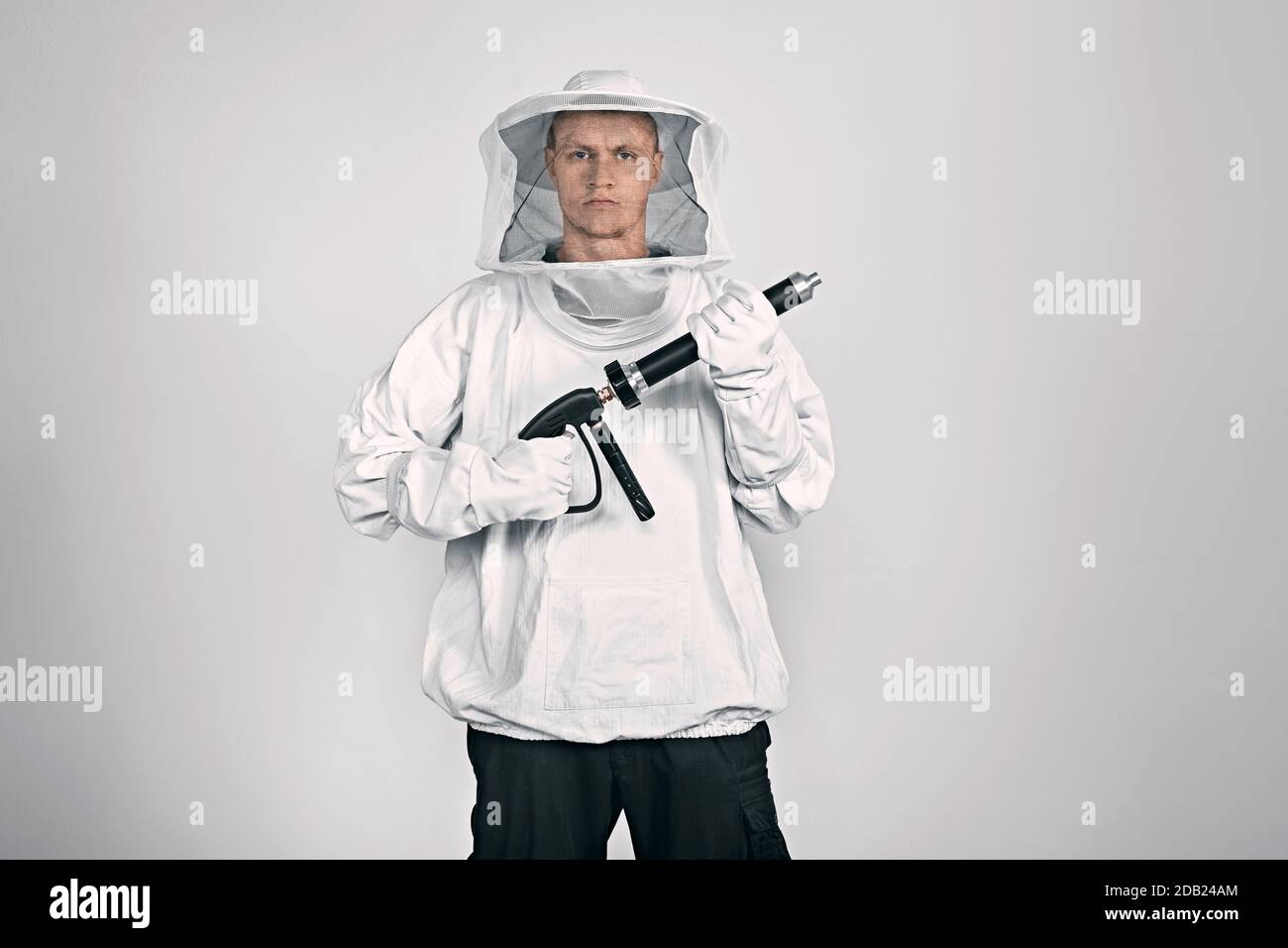 GERMANY / Frankfurt Main /Exterminator is wearing Beekeeper Suit and holding pesticide spray gun. Stock Photo