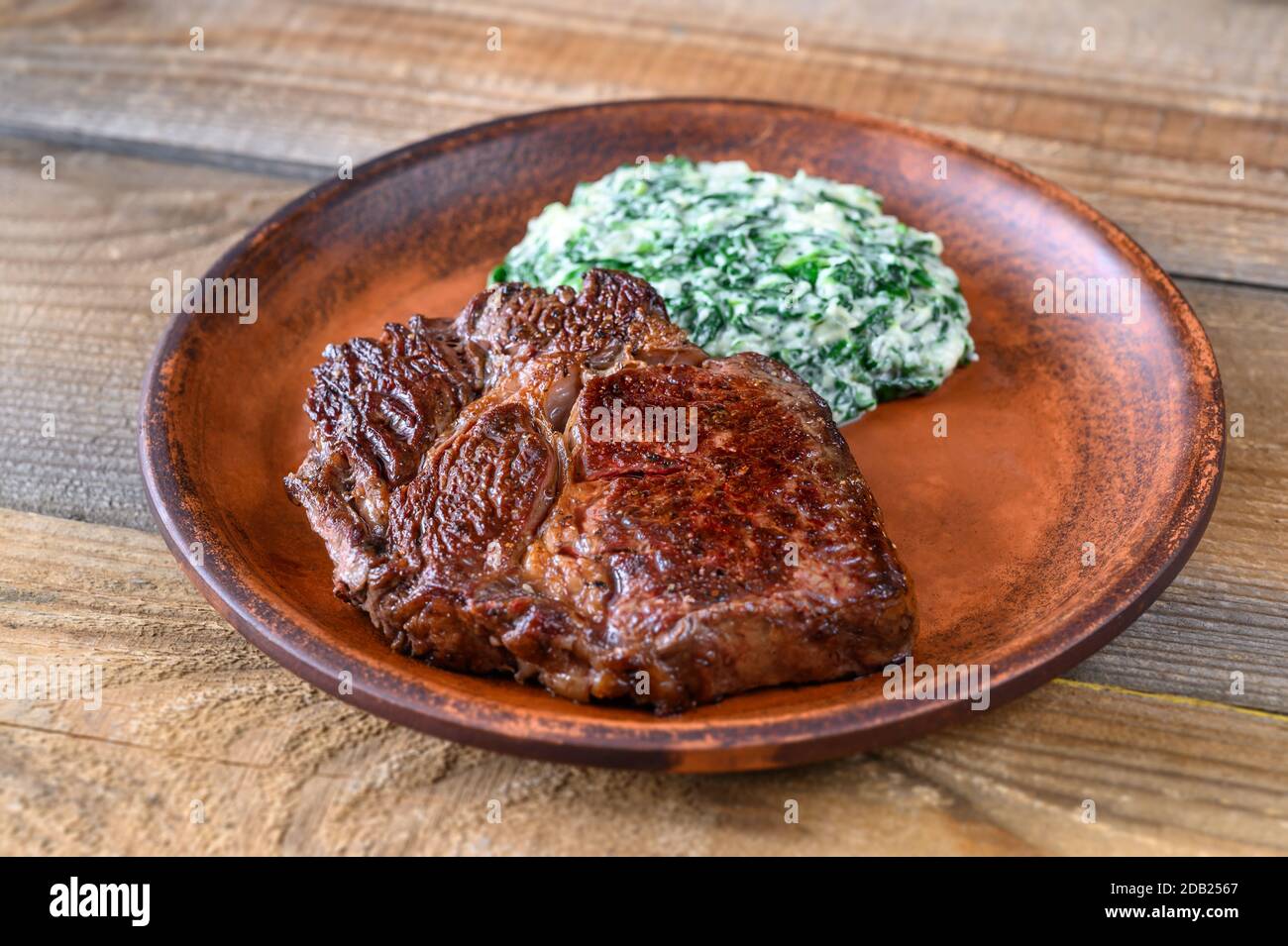 Beef steak with creamy spinach close up Stock Photo