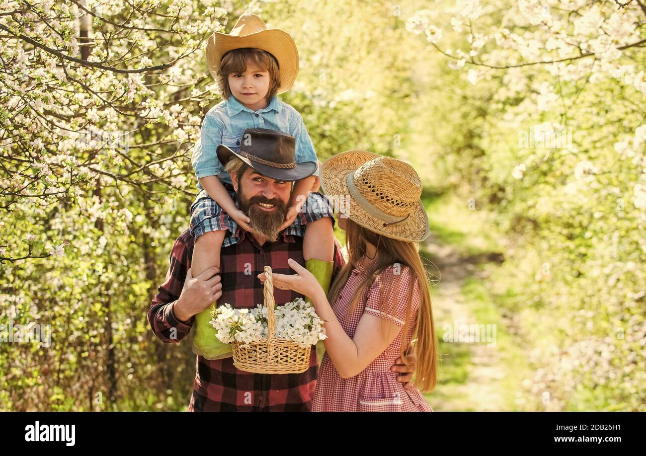 First flowers. Happy family enjoy spring time. Family of three in ...