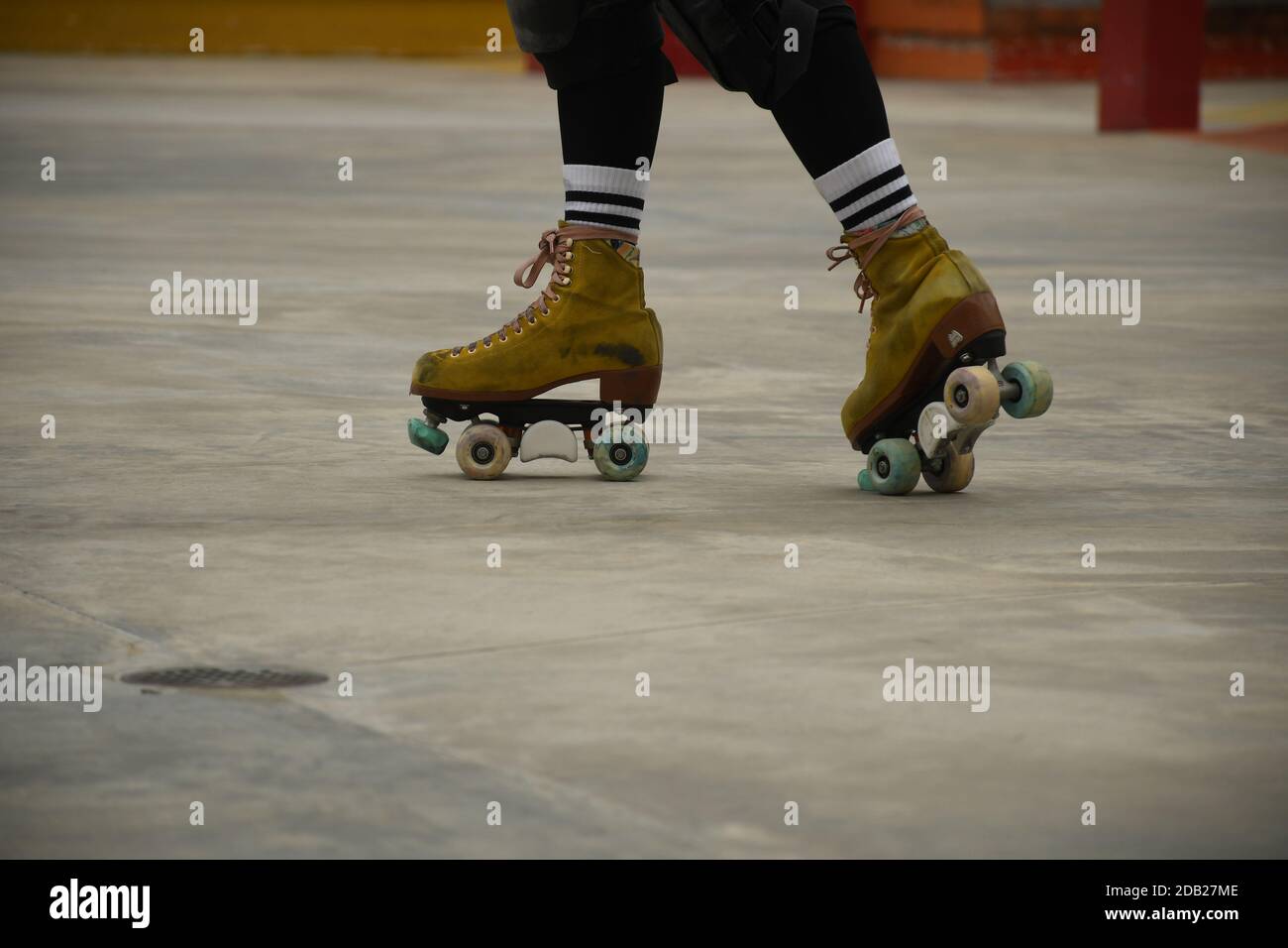 Closeup of the feet of an asian girl using roller skates inside Lai Chi