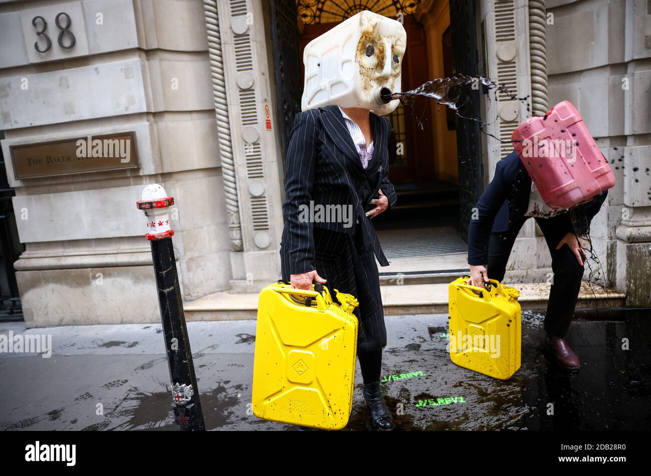 Activists from the climate action group Ocean Rebellion perform a stunt outside The Baltic Exchange building, in London, Britain November 16, 2020. REUTERS/Henry Nicholls Stock Photo