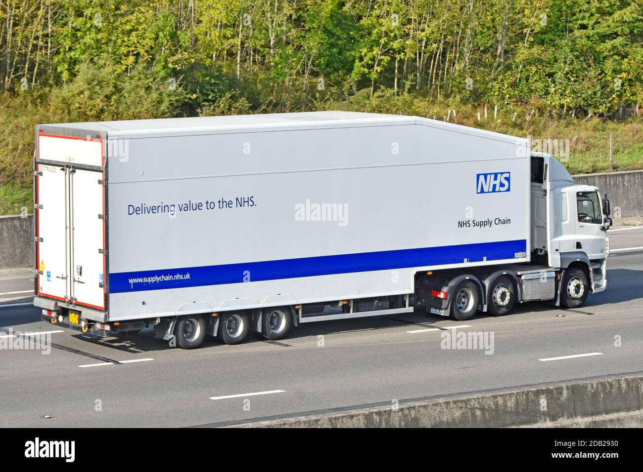 NHS supply chain hgv delivery lorry truck & articulated trailer delivering medical healthcare value to national health service driving on motorway UK Stock Photo