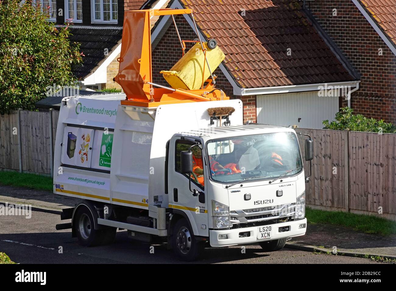 Isuzu urban lorry truck fitted with roof access for hydraulic lift to tip wheelie bin collection of household caddy food waste recycling Brentwood UK Stock Photo