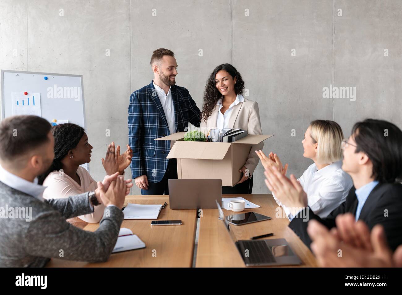 Businessman Introducing New Coworker To Employees During Meeting In Office Stock Photo