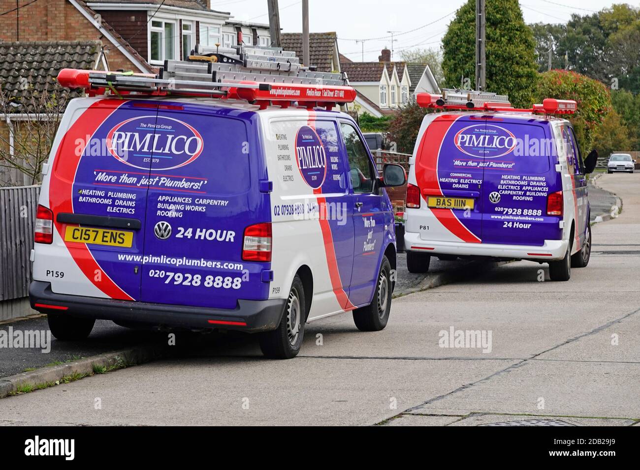 Pimlico plumbers group service business vans outside home vehicle graphics advertising company care services for property maintenance work England UK Stock Photo