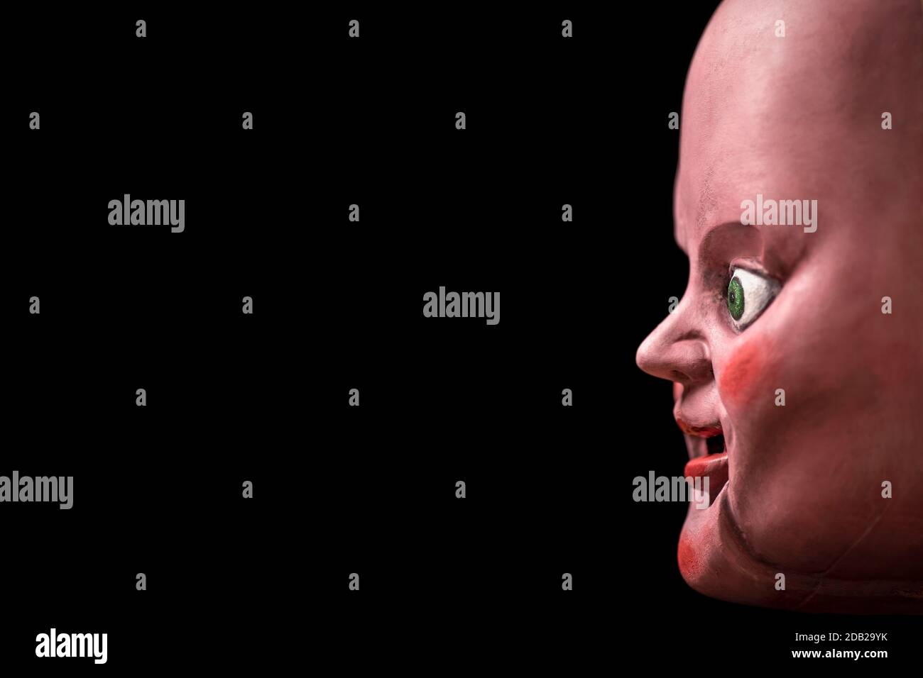 Creepy doll head in the dark Stock Photo