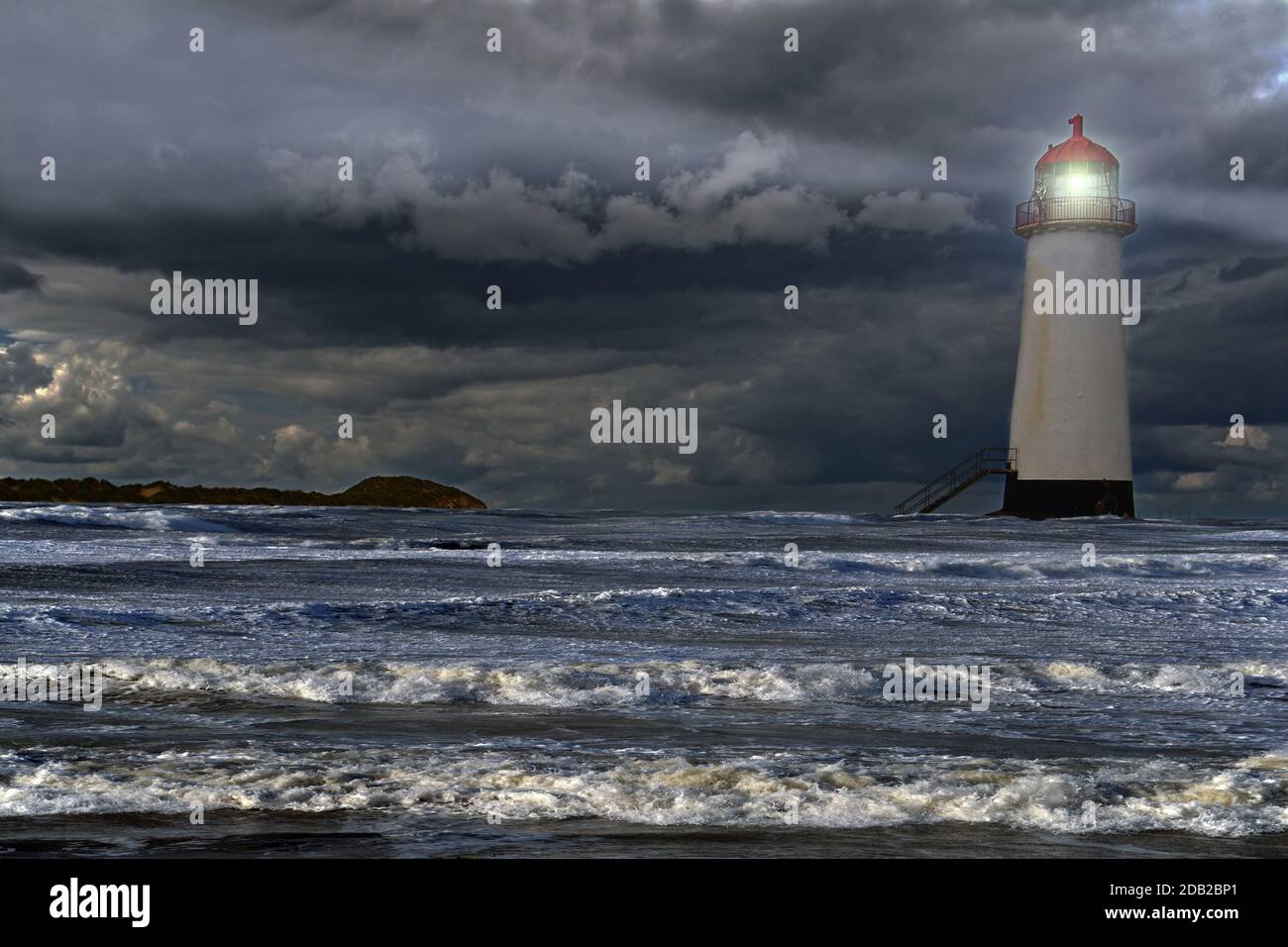 Point of Ayr Lighthouse, a disused lighthouse in the Dee Estuary, has been brought back to life with the magic of Photoshop and added high water. Stock Photo