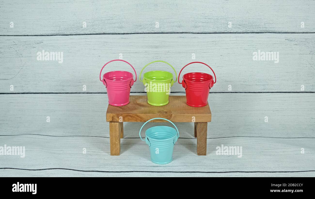 Color mini buckets on wood decor Stock Photo