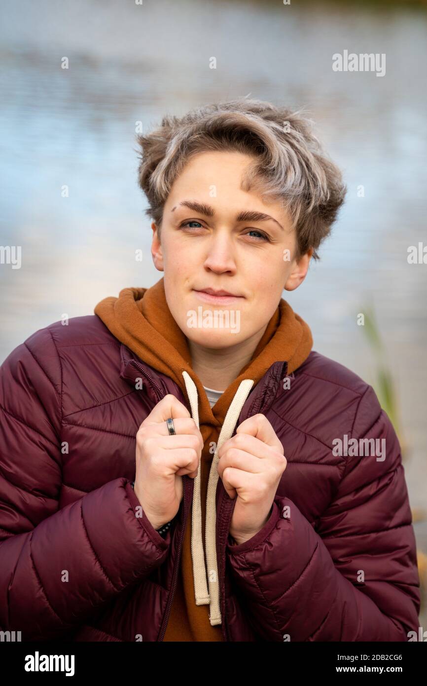 New femininity gender neutral style. Young woman with stylish short