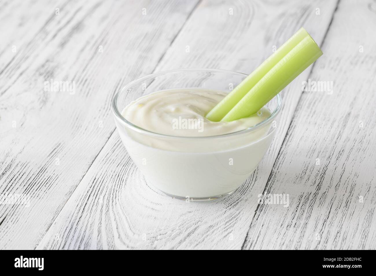 Leaf celery stalk dipped in Greek yogurt Stock Photo Alamy