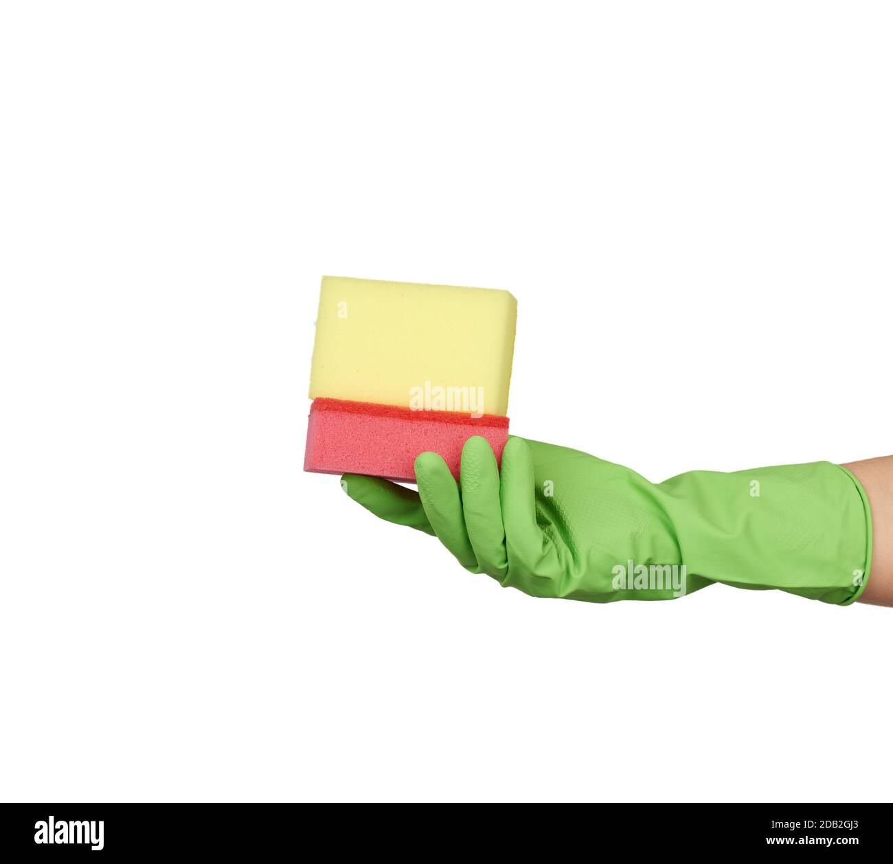 wearing a green glove for cleaning and washing dishes, red and yellow kitchen sponges lies in