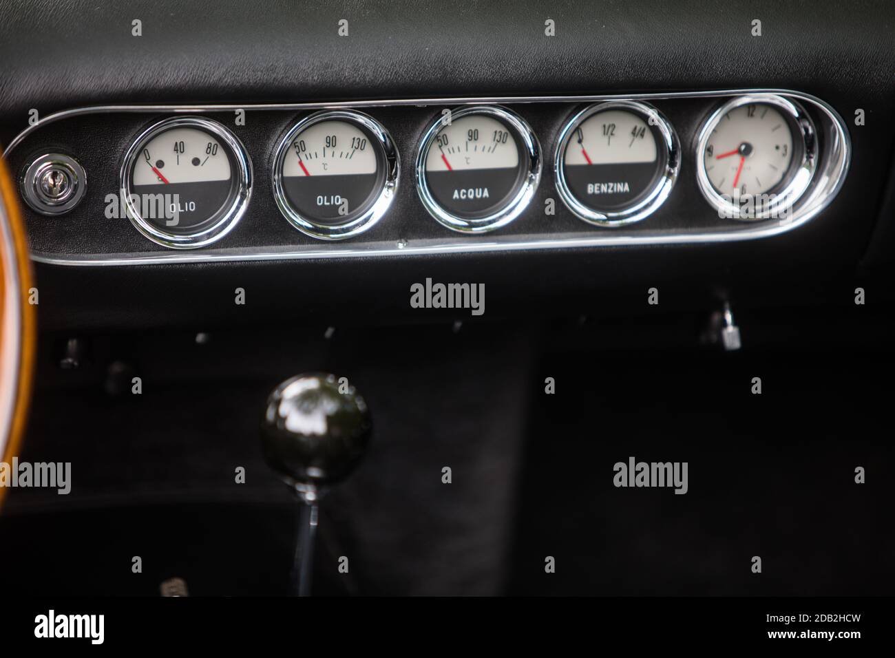 https://c8.alamy.com/comp/2DB2HCW/color-close-up-shot-of-a-clock-fuel-level-and-thermometer-on-a-vintage-cars-dashboard-2DB2HCW.jpg