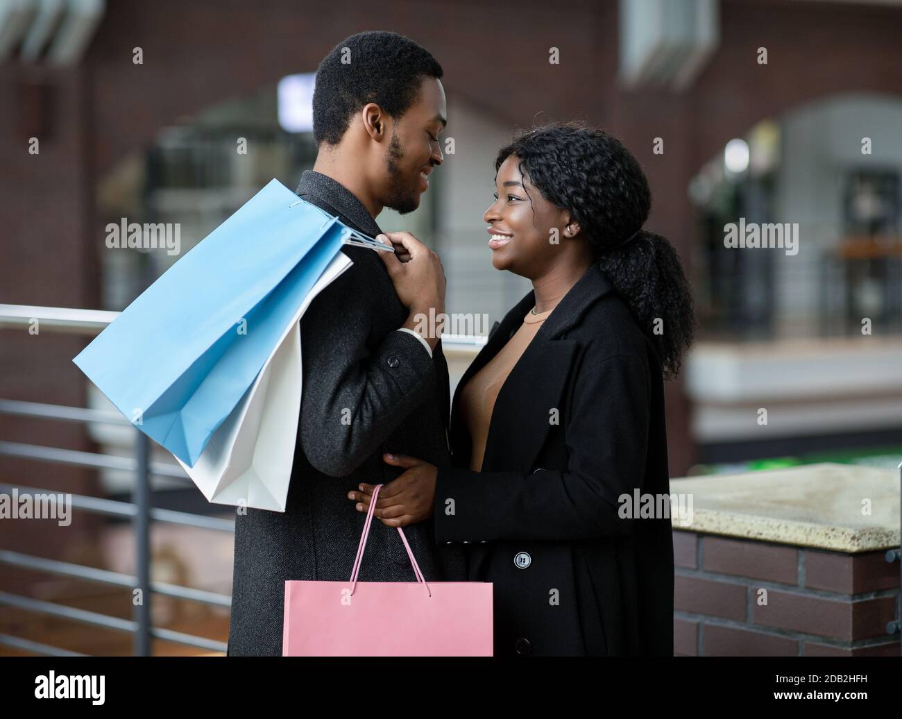 Date couple in love in city mall during black friday and seasonal sales before holidays Stock Photo