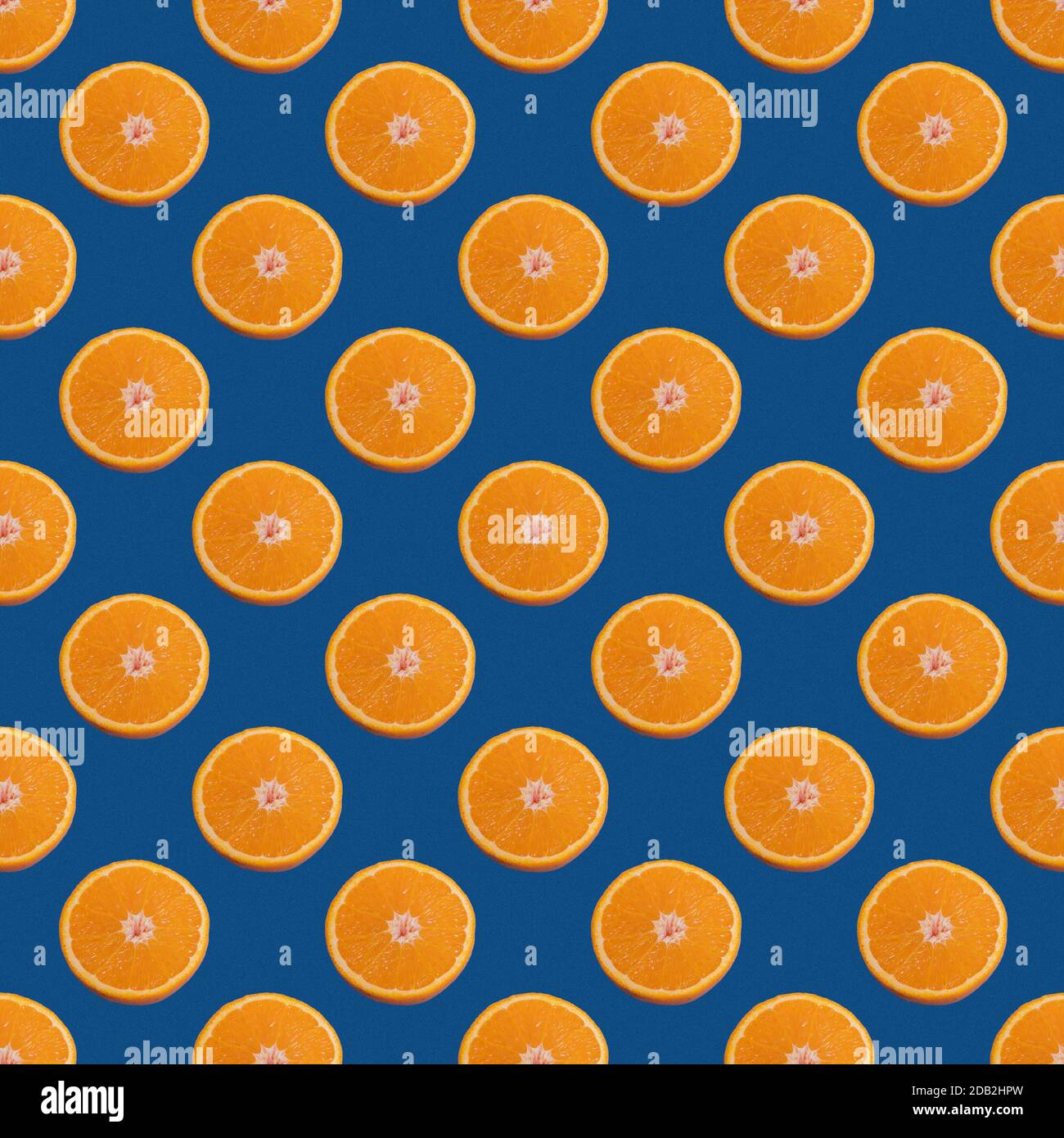 https://c8.alamy.com/comp/2DB2HPW/seamless-pattern-of-half-orange-isolated-on-a-classic-blue-background-minimal-food-texture-fruit-background-2DB2HPW.jpg