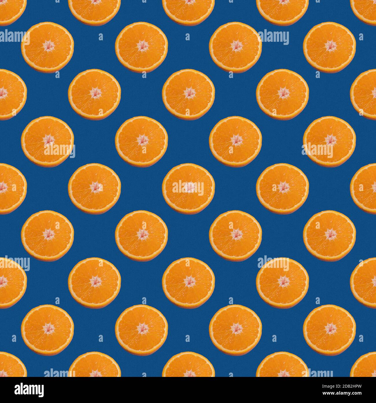 Seamless pattern of half orange isolated on a classic blue background
