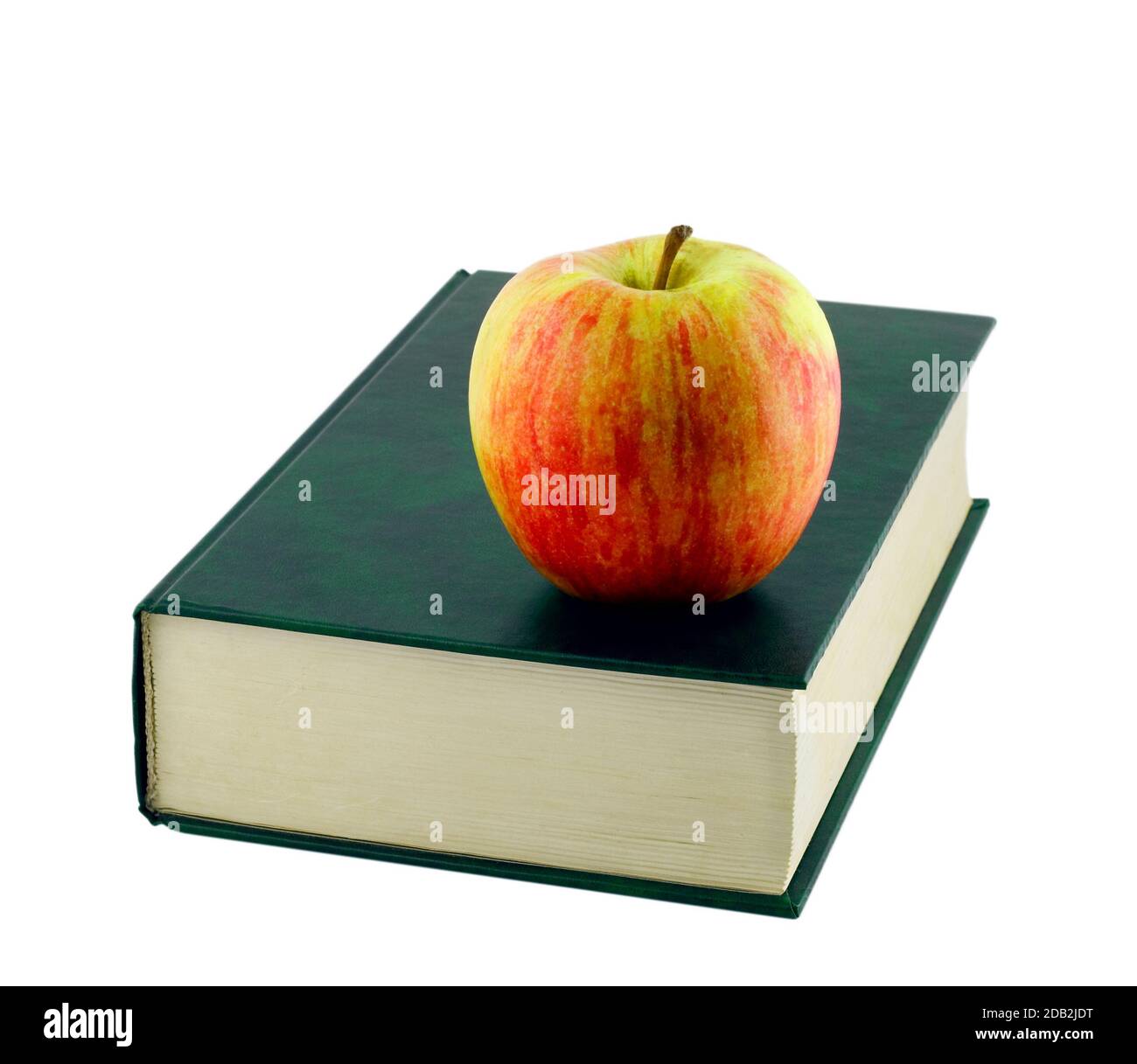 Apple on book isolated on white background Stock Photo - Alamy