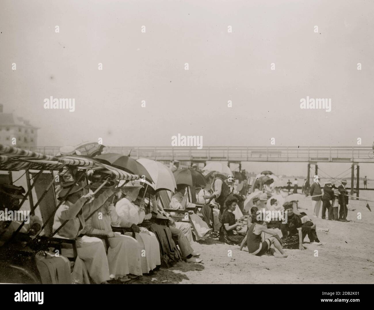 Spectators seated in beach chairs with awnings watches the motor boat ...