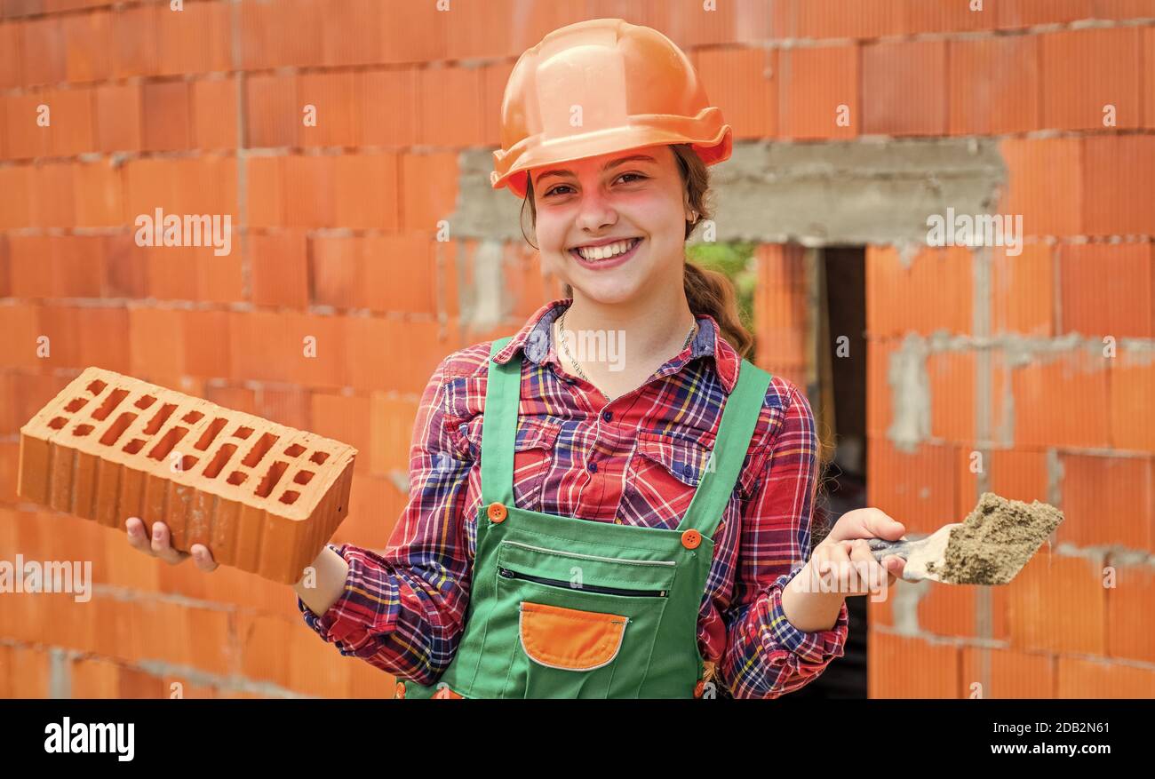 Architecture construction child. Child in uniform working around brick