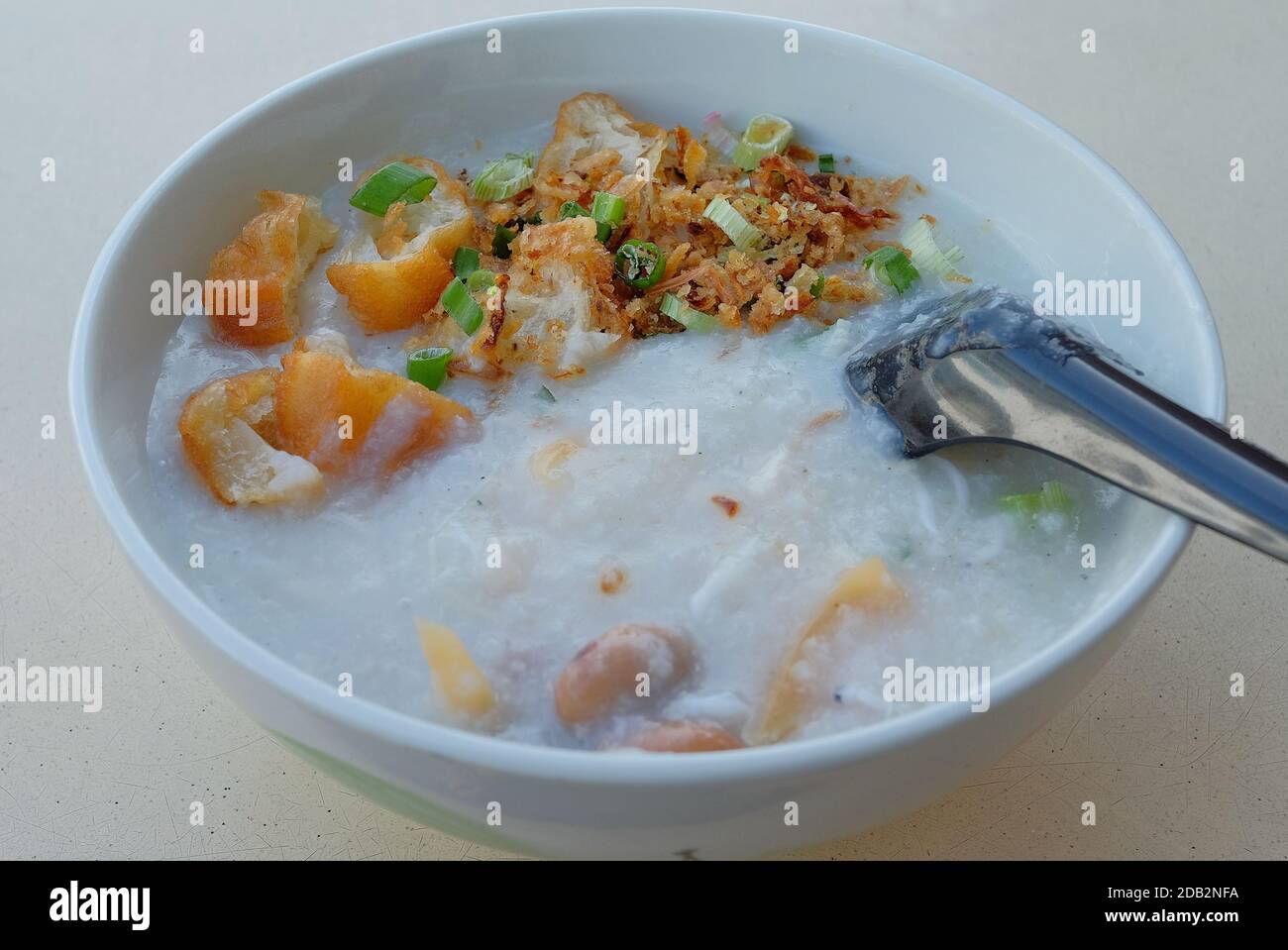 A bowl of Cantonese Ting Zai Porridge or Congee, with slices of fresh