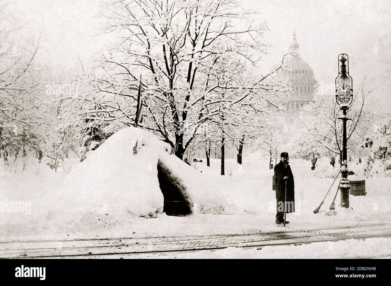 Man standing by snow hut, after blizzard of 1888, with U.S. Capitol in background, Washington, D.C.. Stock Photo