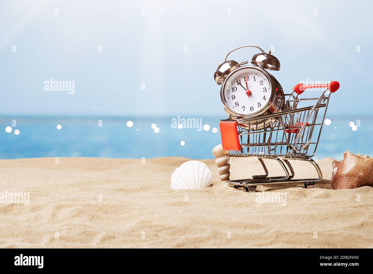Alarm Clock In Sand On Sunny Tropical Beach Stock Photo