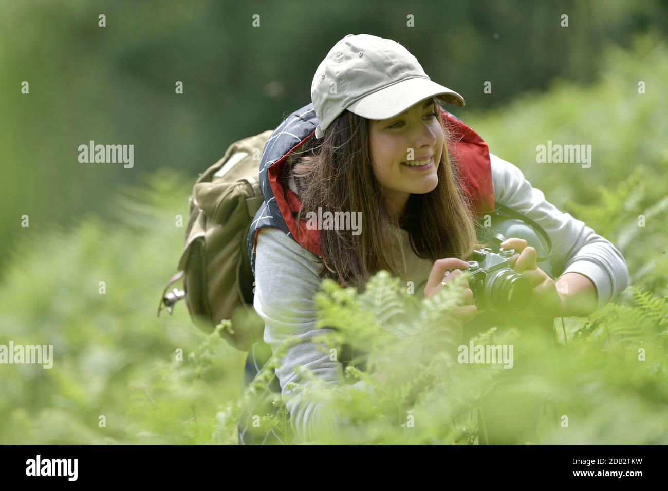 Young woman taking pictures during walk in nature Stock Photo - Alamy