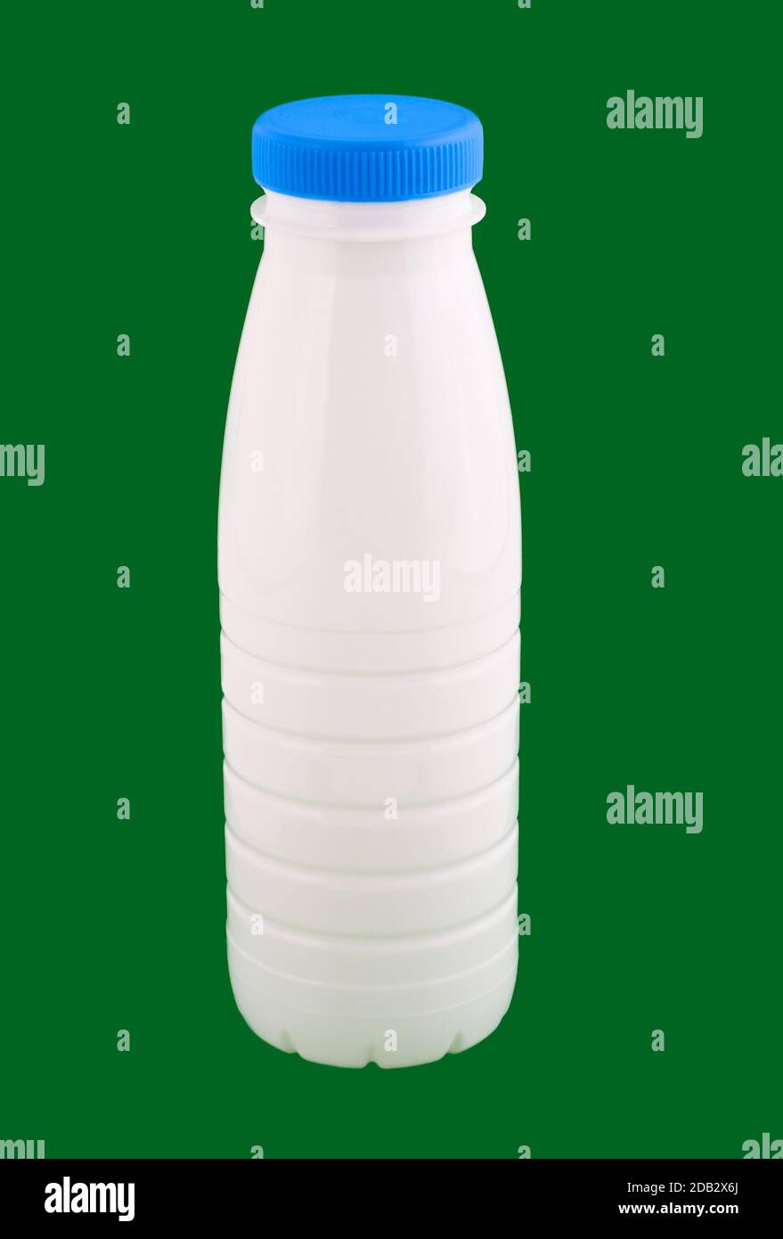 plastic yogurt bottle, isolated on green background Stock Photo