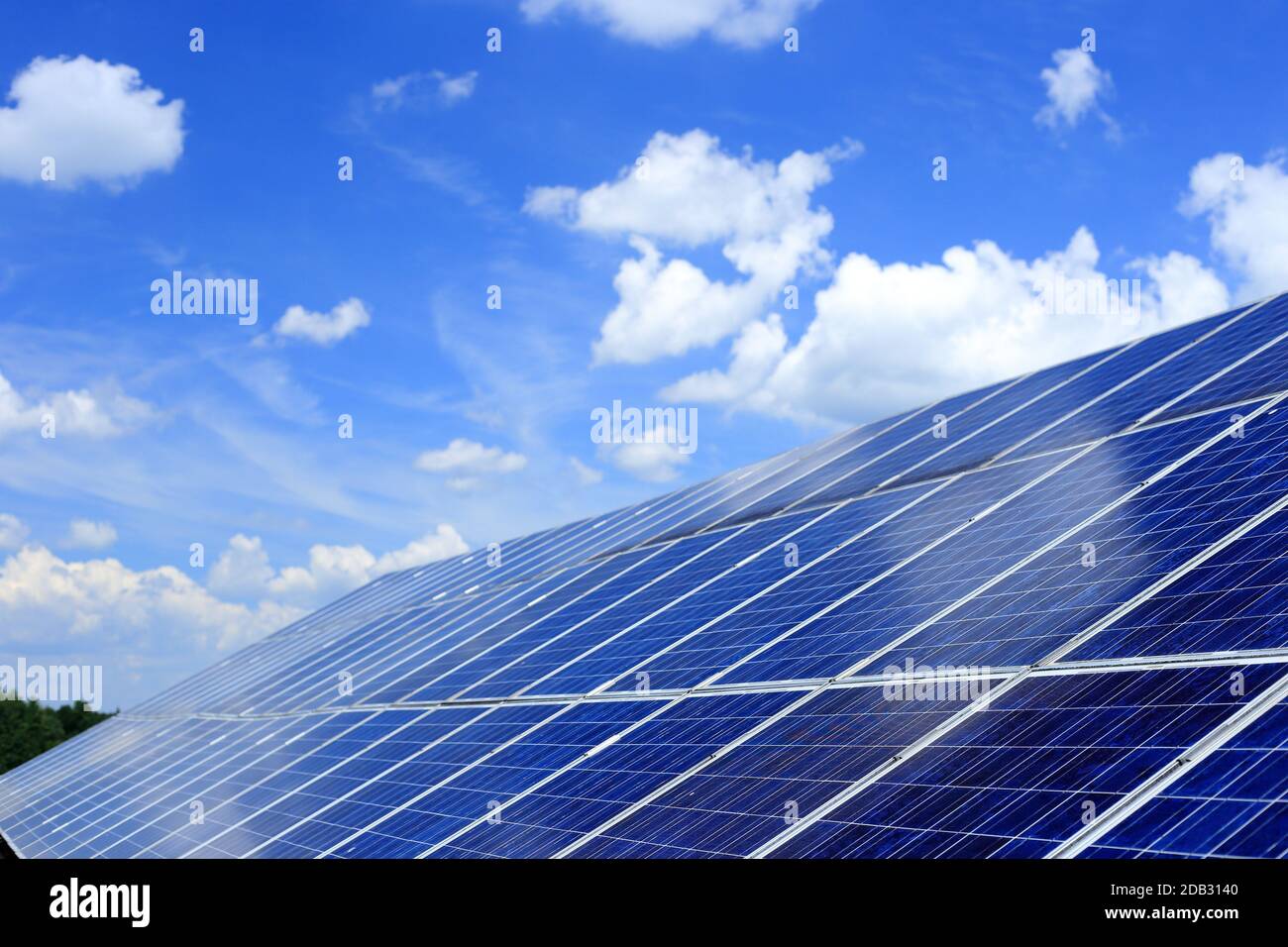 many solar modules for energy with sky in background Stock Photo
