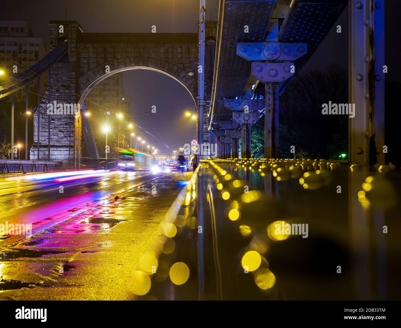 night urban scene, transport driving thru a suspension bridge. Stock Photo