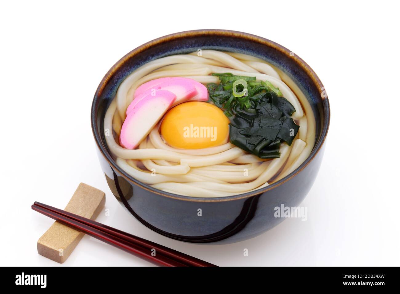 Japanese Tukimi udon noodles in a bowl with chopsticks on white background Stock Photo