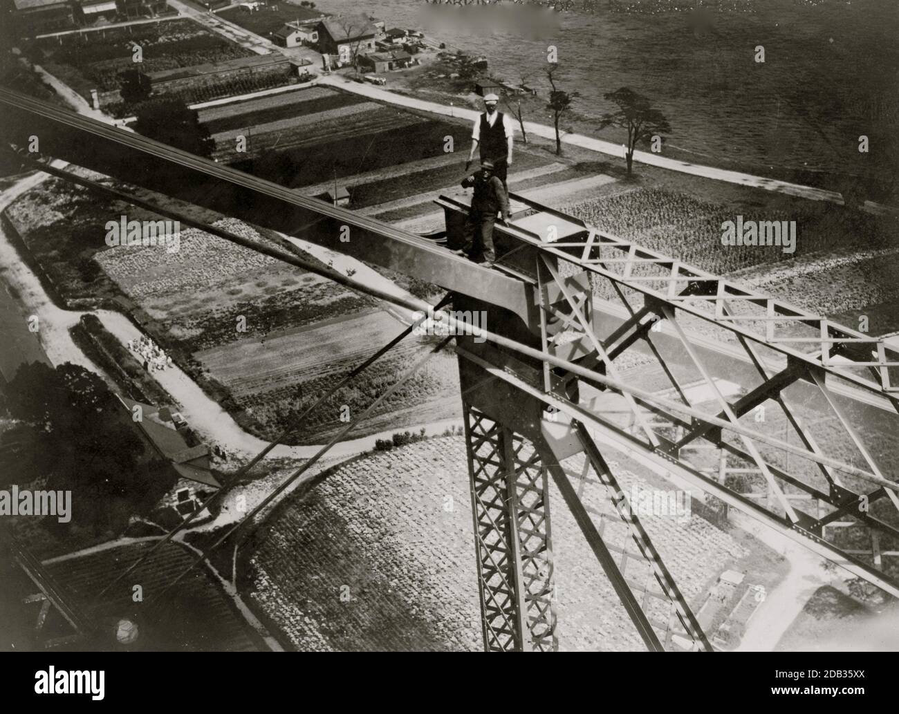 Two men working on top of Blackwell's Island bridge, during