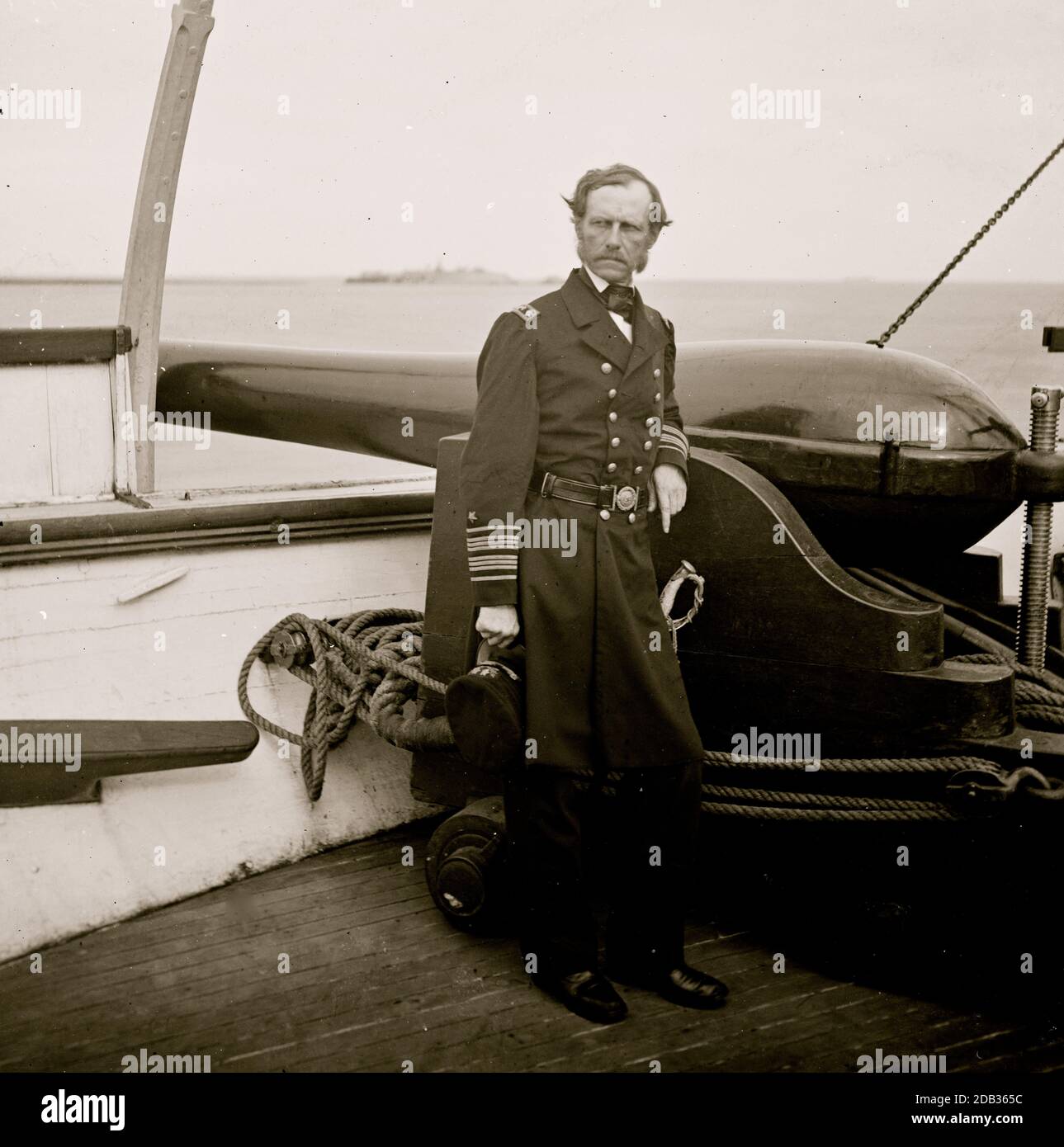 Charleston Harbor, S.C. Rear Admiral John A. Dahlgren standing by a Dahlgren gun on deck of U.S.S. Pawnee. Stock Photo