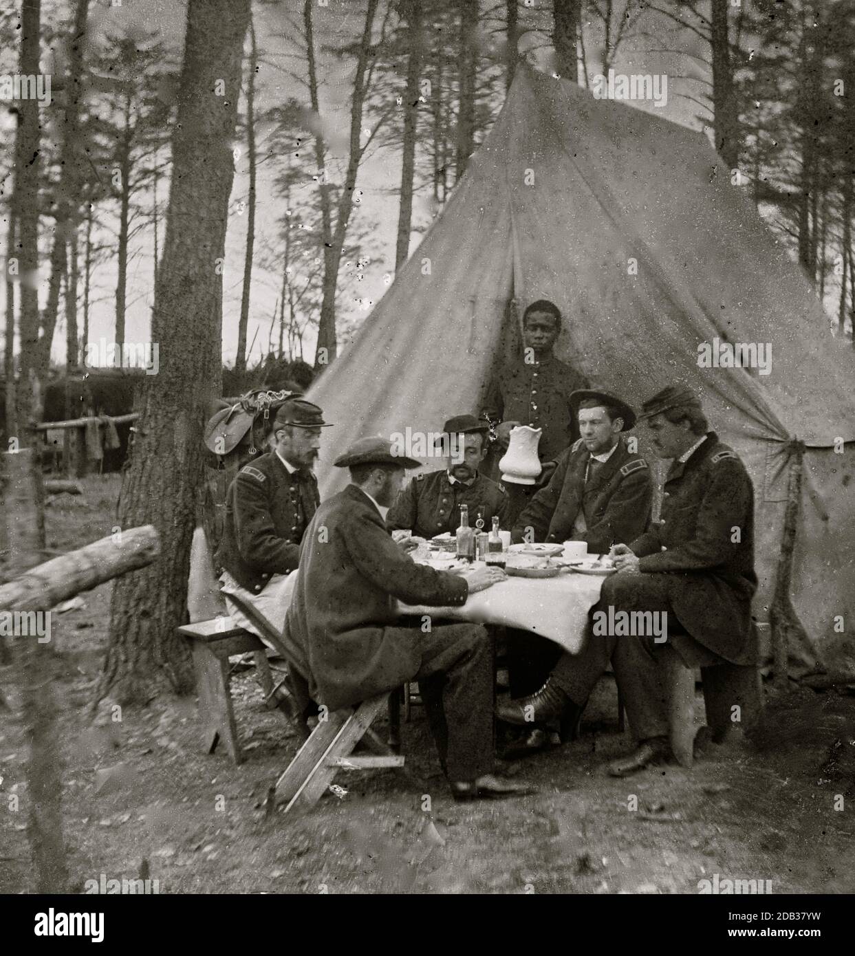Brandy Station, Va. Dinner party outside tent, Army of the Potomac headquarters; Black Youth serves as a waiter. Stock Photo