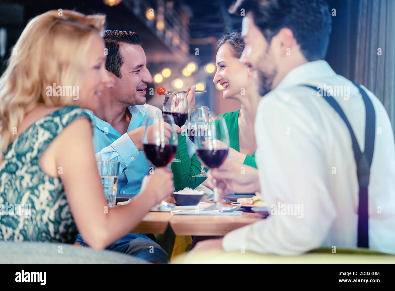 People in an upscale restaurant eating and drinking red wine Stock ...