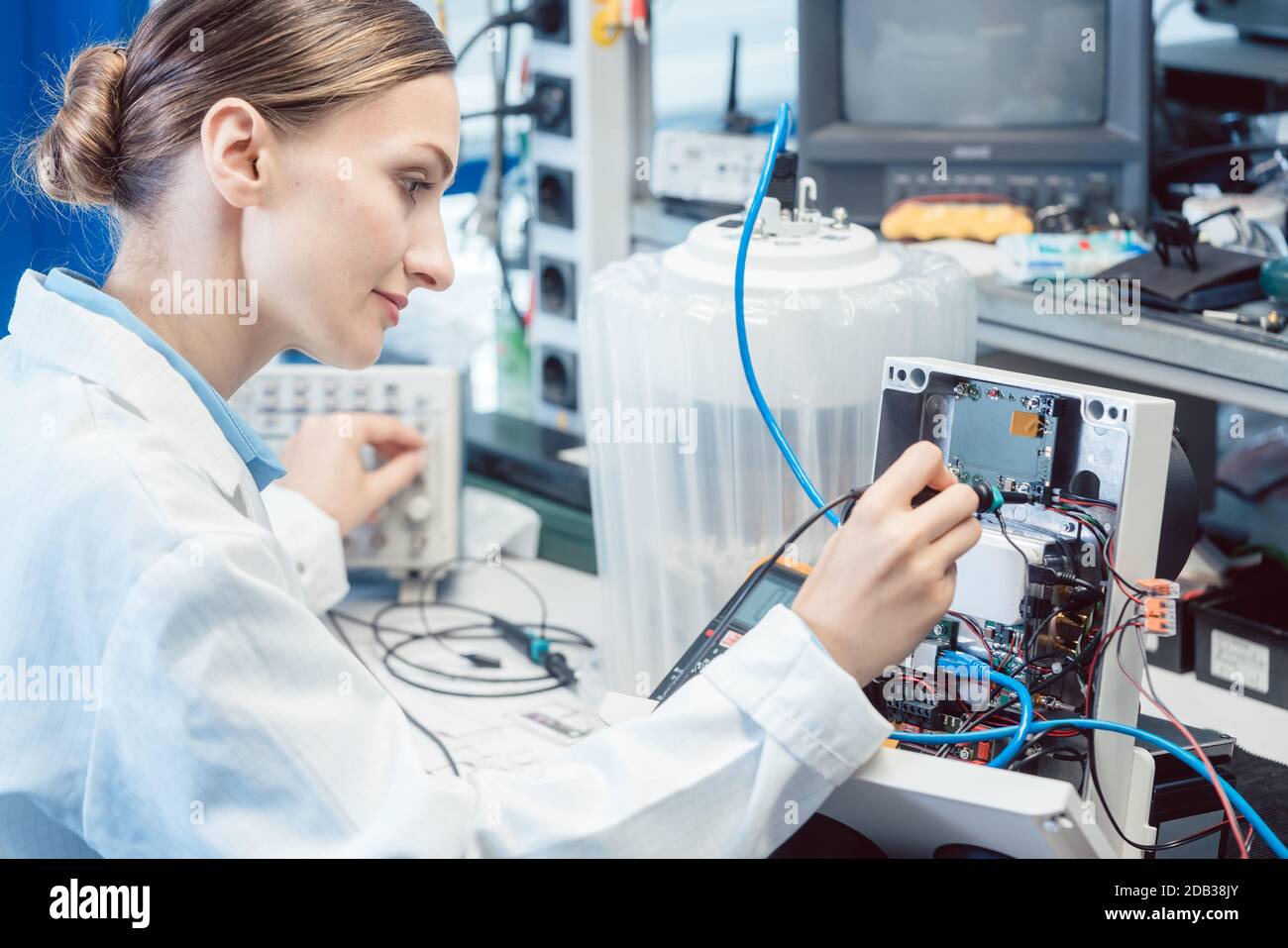 Engineer woman measuring electronic product on test bench in her lab