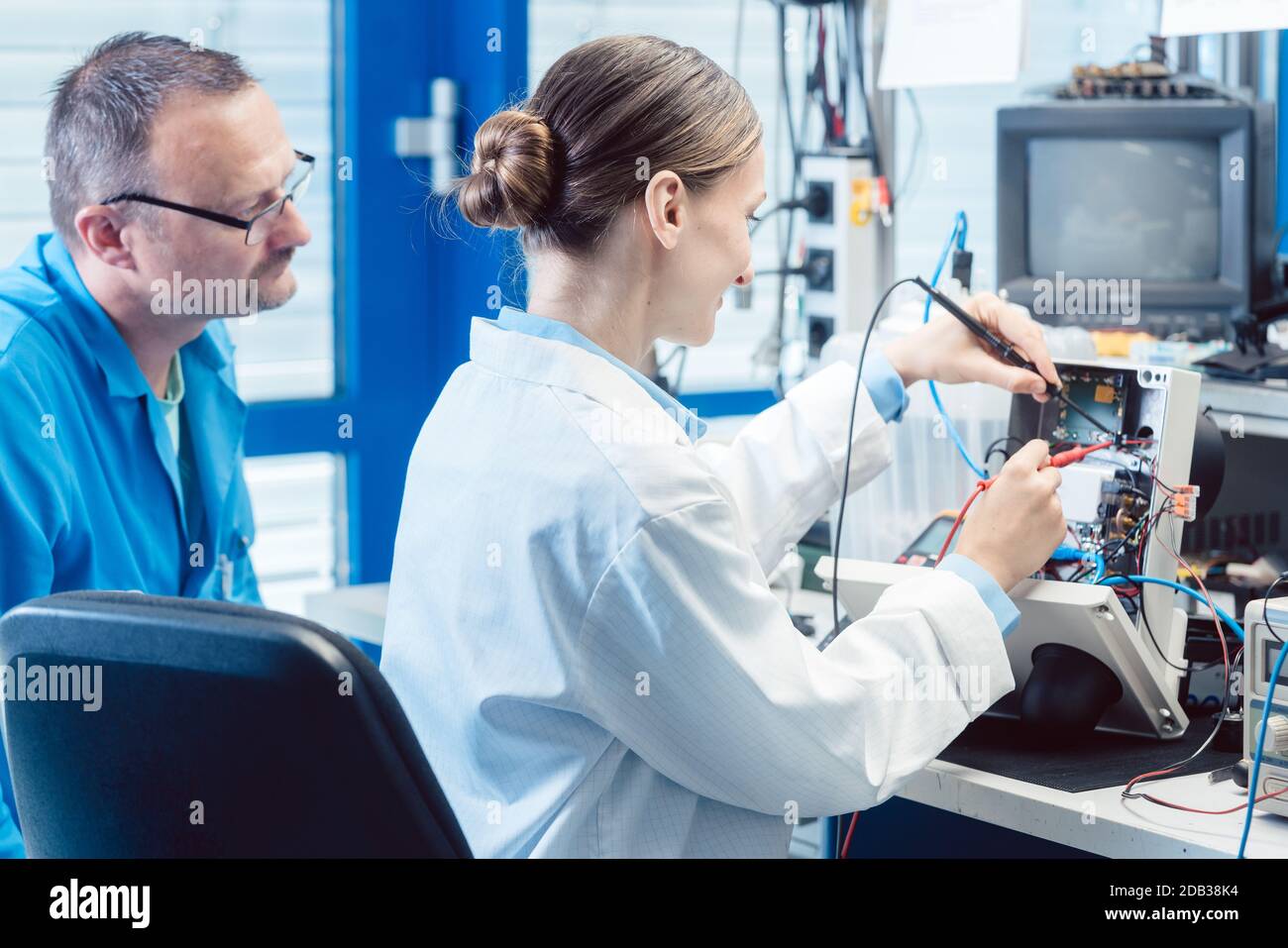 Team of electronic engineers testing a product prototype on test bench