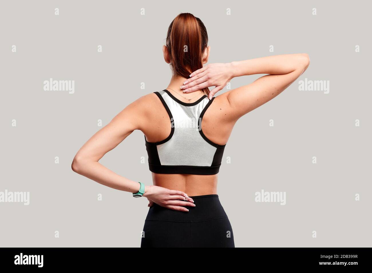 Female body showing pain in back spine. Sportswoman feeling acute pain in  neck on white background.Medical concept Stock Photo - Alamy