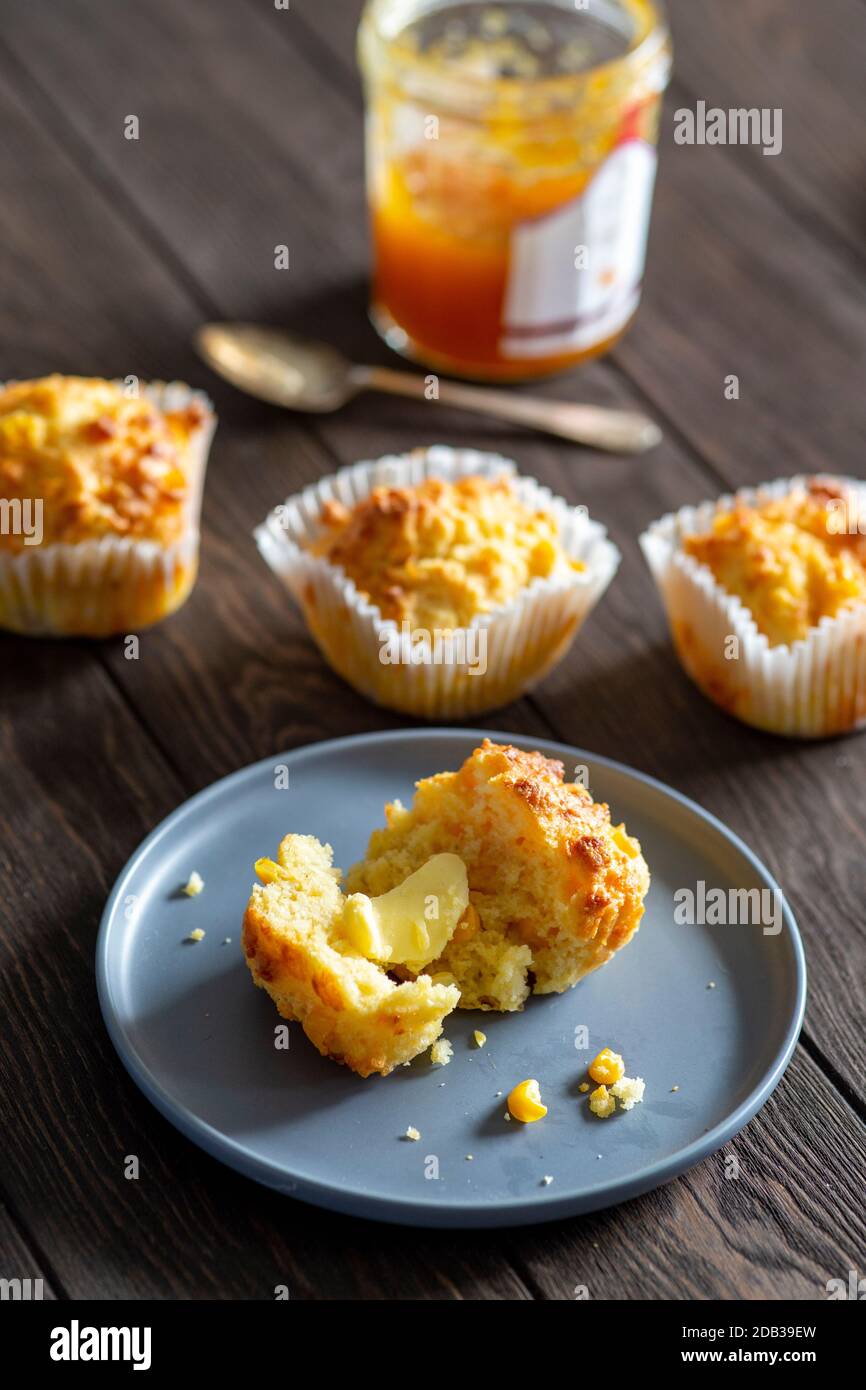 Cornbread Muffins with Butter and Jam and a Spoon on a Blue Plate on a Wooden Background - FOODPIX Stock Photo