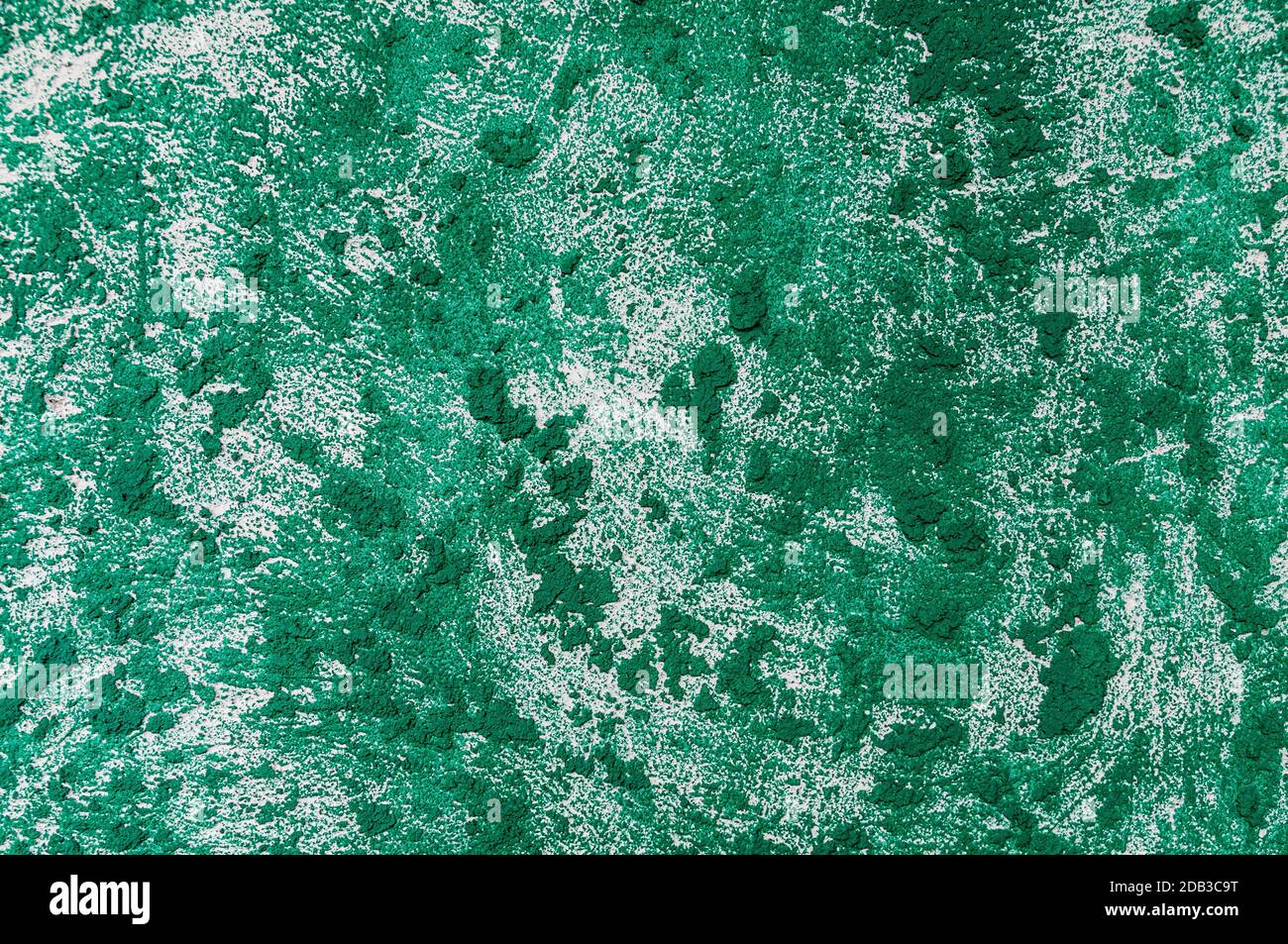 texture of the wall covered with relief plaster and painted green Stock Photo