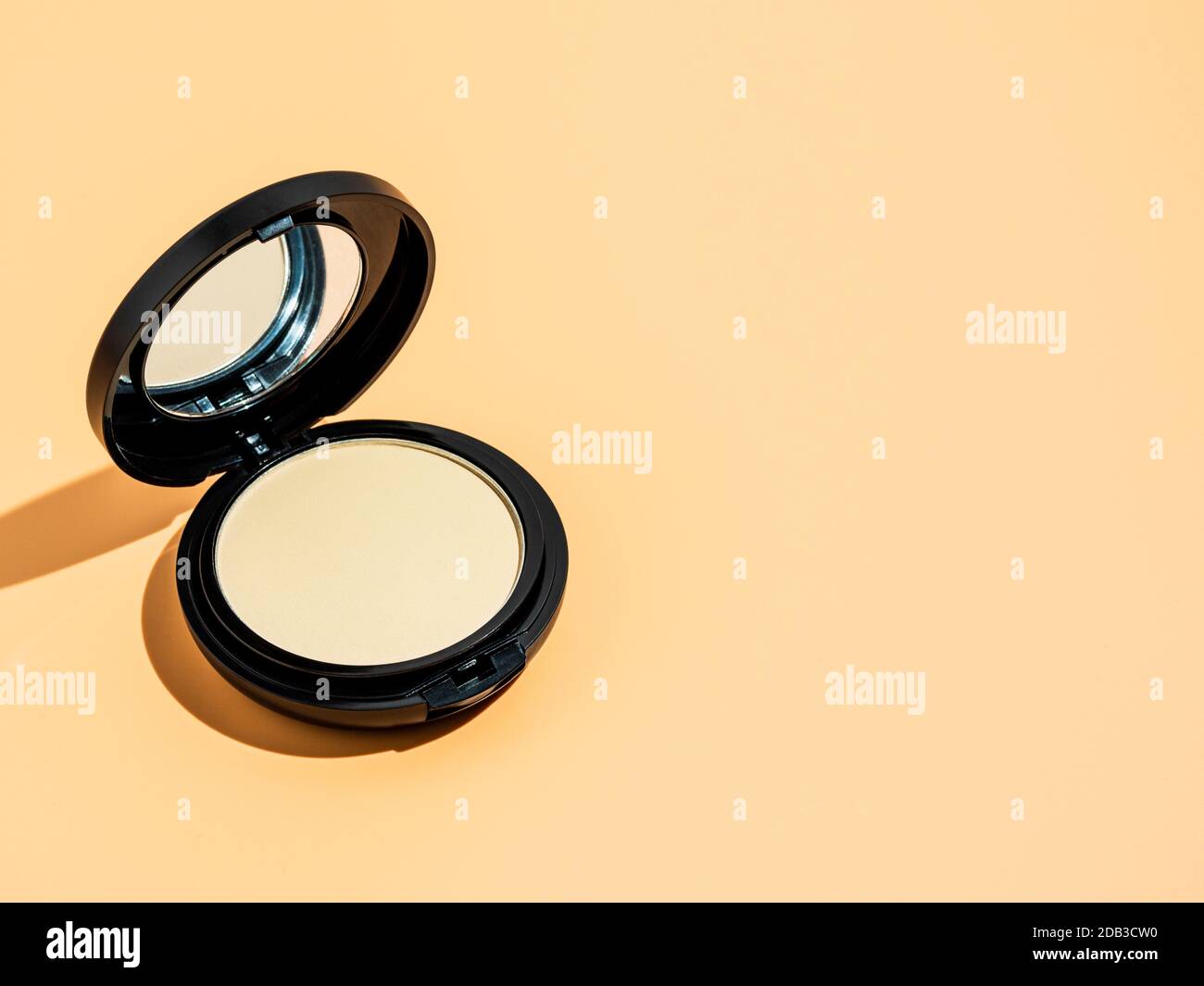 Compact Powder On Yellow Or Cream Background Female Pressed Powder In Ajar Opened Black Plastic Case With Mirror Copy Space For Text Or Design Hard Light Stock Photo Alamy