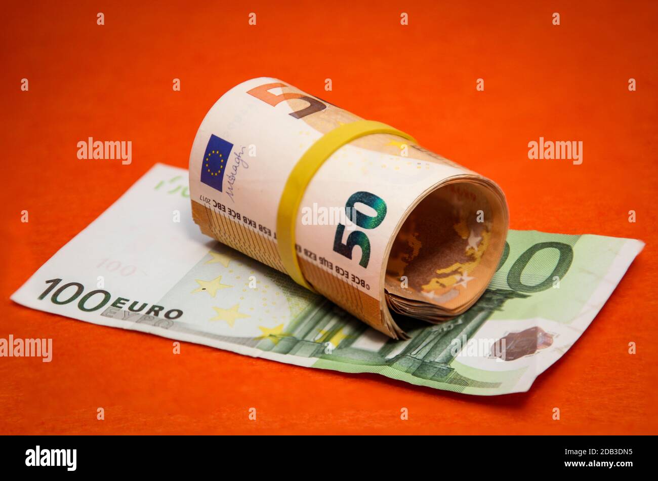 a roll with fifties is on a hundred euro note Stock Photo