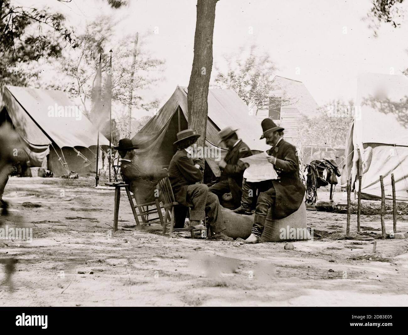 Gen. Ambrose E. Burnside (reading newspaper) with Mathew B. Brady (nearest tree) at Army of the Potomac headquarters. Stock Photo