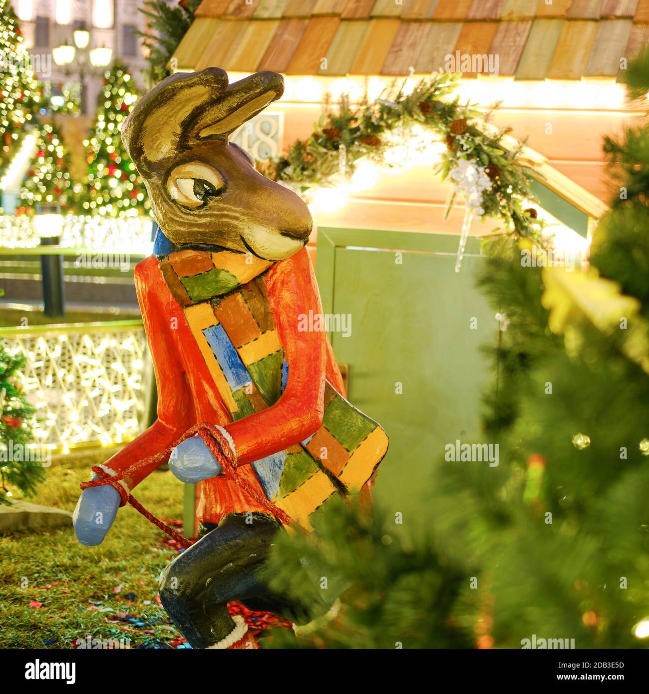 Figurine rabbit near the Christmas tree, decoration for the new year. Christmas composition in Moscow on Manezhnaya square - Moscow, Russia, December, Stock Photo
