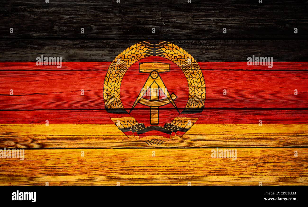 East Germany German Democratic Republic national flag colors painted on old wooden plank background Stock Photo