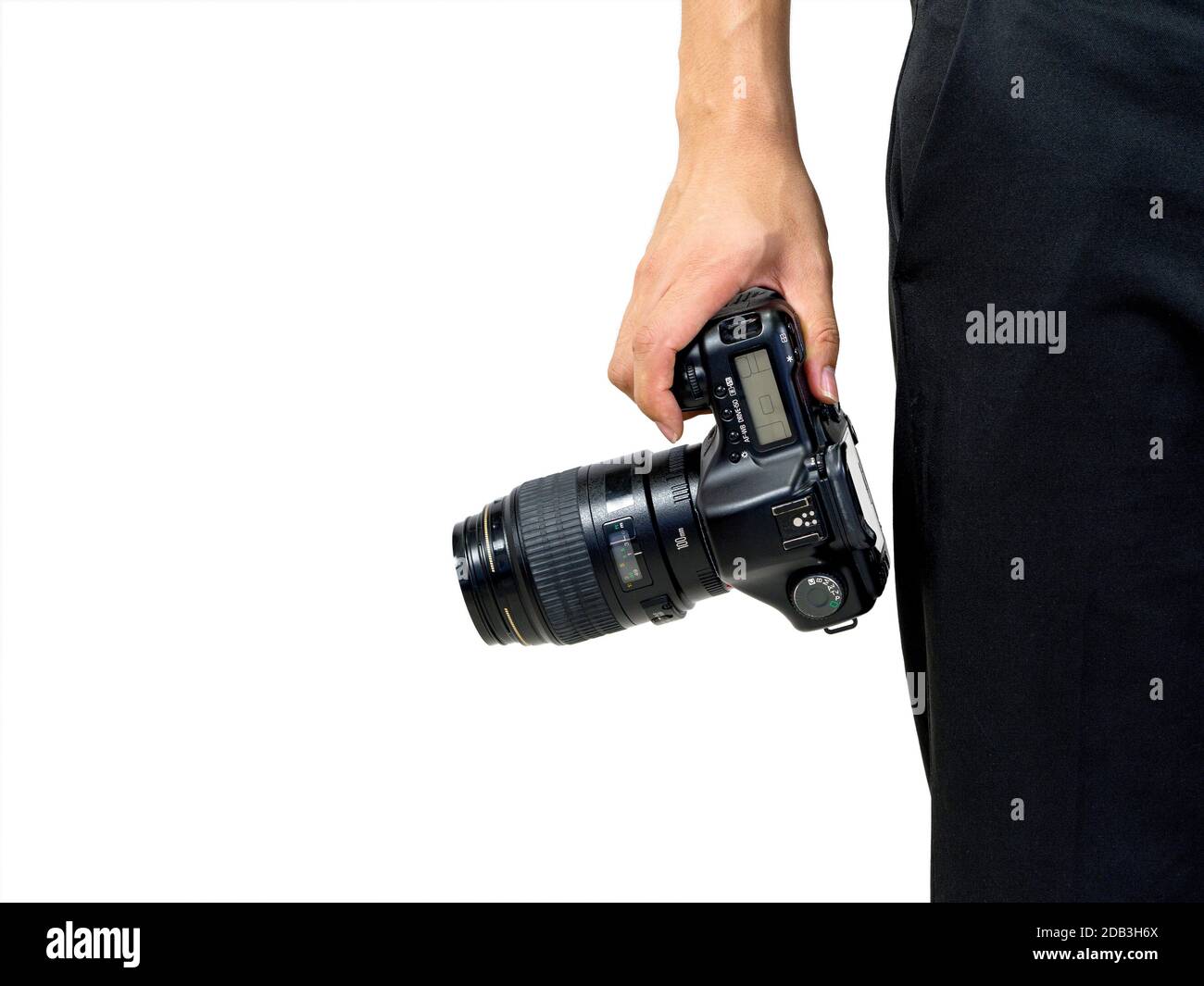 The photographer holds the camera by hand in the hip position Stock ...