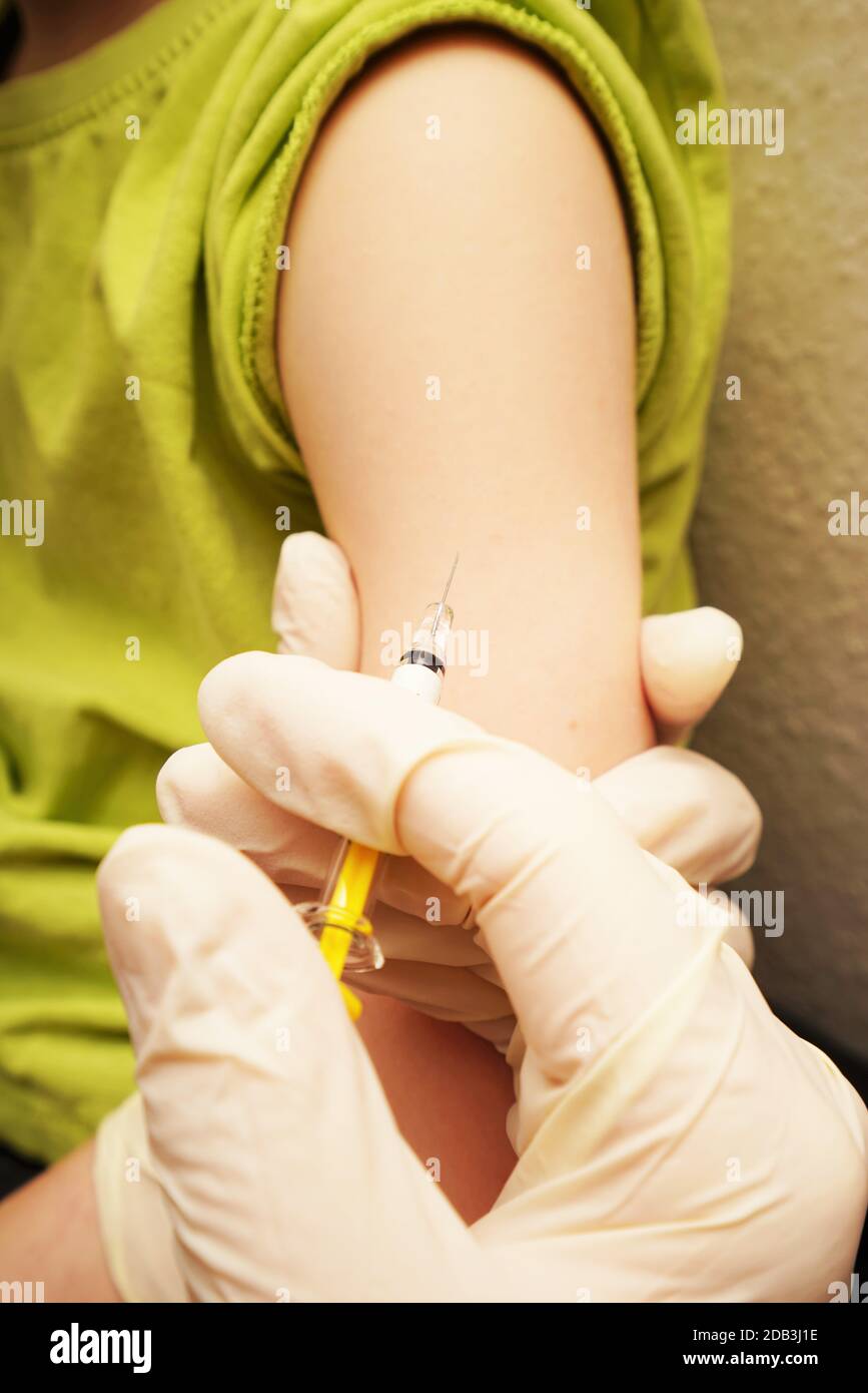 Vaccination in the arm of a child Stock Photo