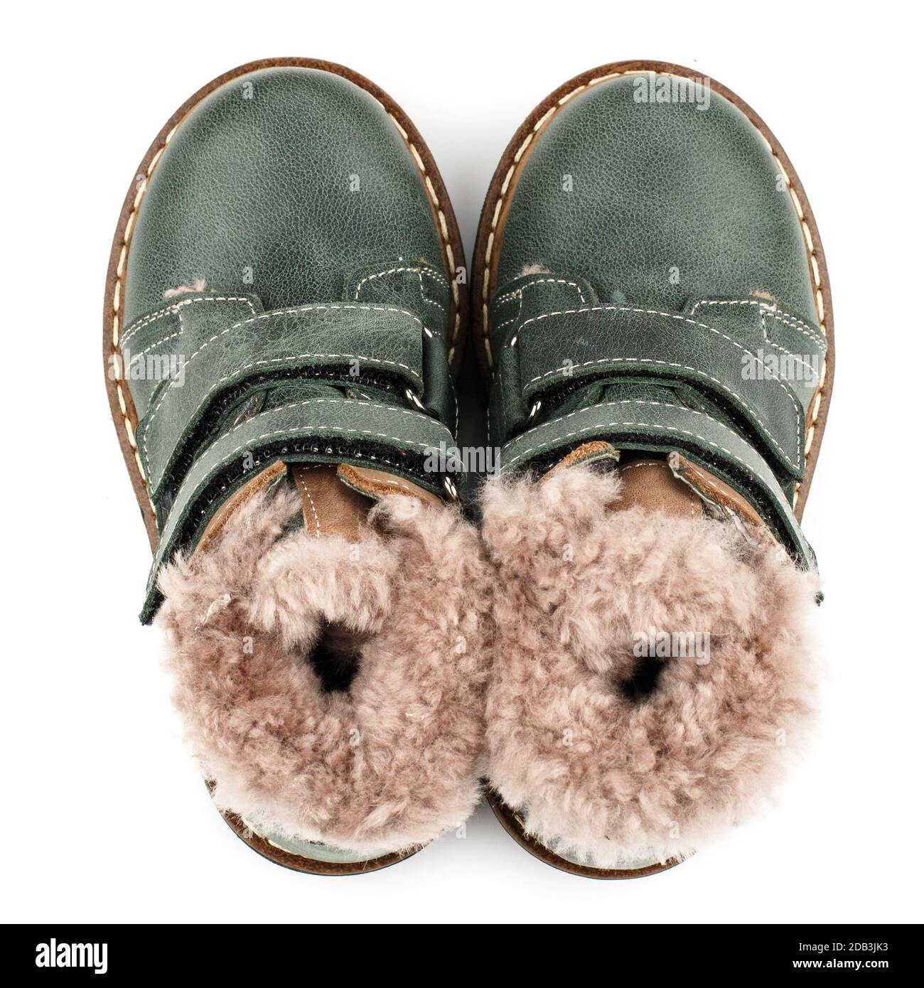Green baby shoes with fur for boys on a white background. Photo for ...